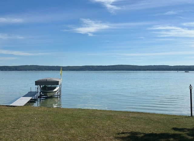 11375 SW Torch Lake Dr, Rapid City, MI 49676 - dock with boat lift and a water view