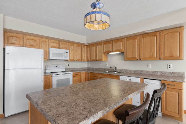 11375 SW Torch Lake Dr, Rapid City, MI 49676 - kitchen with white appliances, a sink, light tile patterned flooring, a breakfast bar, and decorative light fixtures