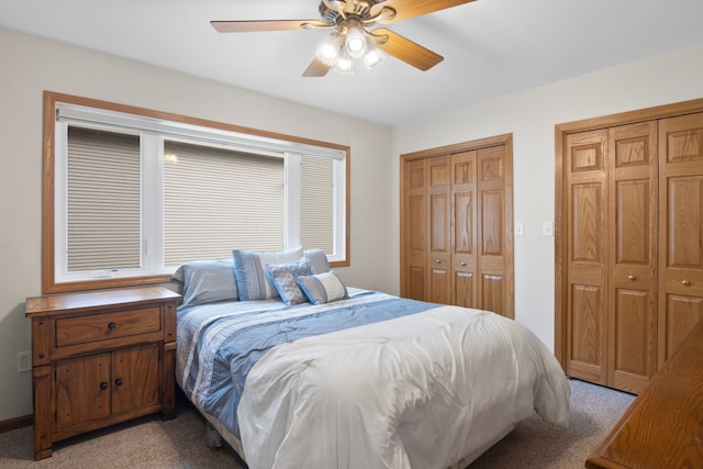 11375 SW Torch Lake Dr, Rapid City, MI 49676 - bedroom with multiple closets, light carpet, and a ceiling fan