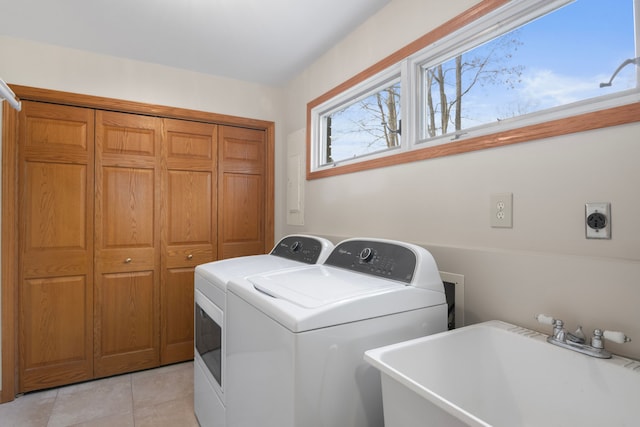 11375 SW Torch Lake Dr, Rapid City, MI 49676 - laundry room featuring light tile patterned floors and washing machine and dryer
