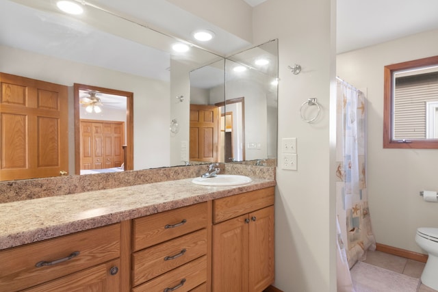 11375 SW Torch Lake Dr, Rapid City, MI 49676 - bathroom with toilet, tile patterned flooring, vanity, curtained shower, and ceiling fan
