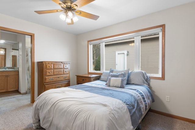 11375 SW Torch Lake Dr, Rapid City, MI 49676 - bedroom featuring light colored carpet, baseboards, connected bathroom, and a ceiling fan