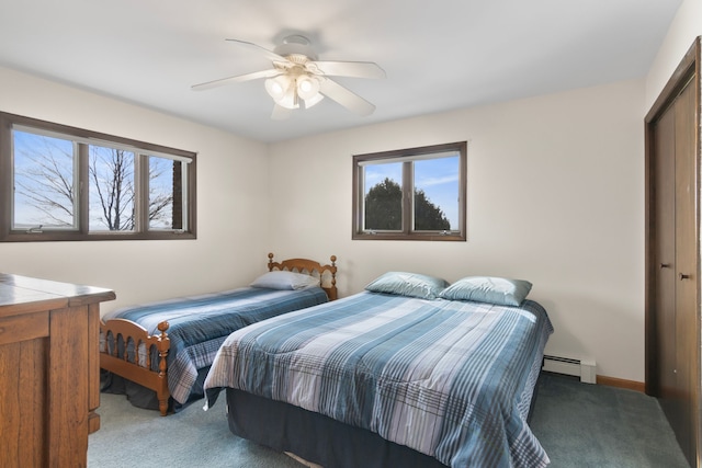 11375 SW Torch Lake Dr, Rapid City, MI 49676 - bedroom with carpet floors, baseboard heating, multiple windows, and ceiling fan