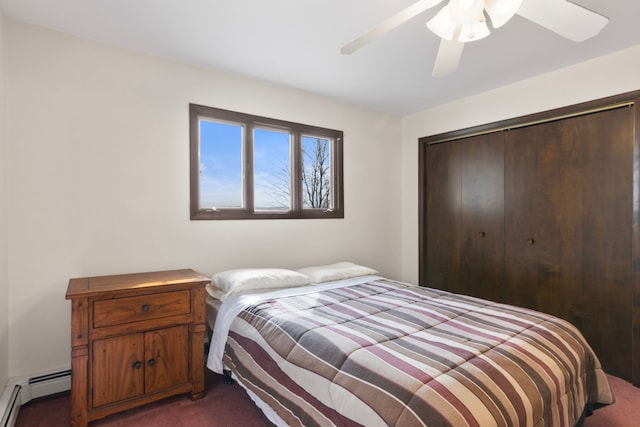 11375 SW Torch Lake Dr, Rapid City, MI 49676 - bedroom featuring a baseboard heating unit, dark carpet, a closet, and a ceiling fan