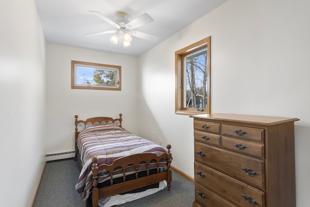 11375 SW Torch Lake Dr, Rapid City, MI 49676 - bedroom featuring a baseboard heating unit, carpet, baseboards, and a ceiling fan