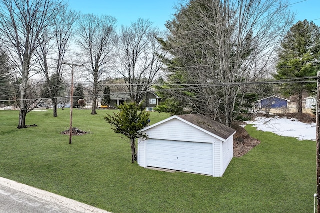 11375 SW Torch Lake Dr, Rapid City, MI 49676 - view of green lawn with an outbuilding and a garage