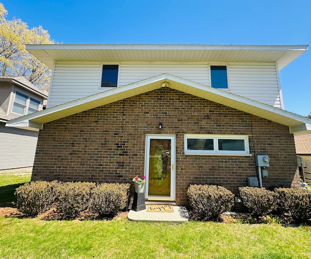 11375 SW Torch Lake Dr, Rapid City, MI 49676 - view of front facade with brick siding