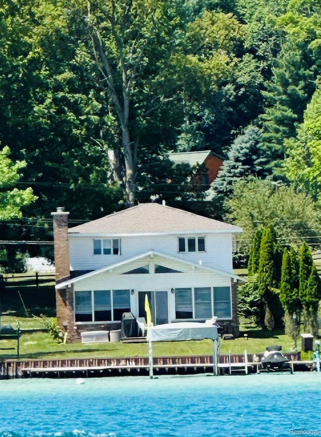 11375 SW Torch Lake Dr, Rapid City, MI 49676 - back of property with a chimney and a water view