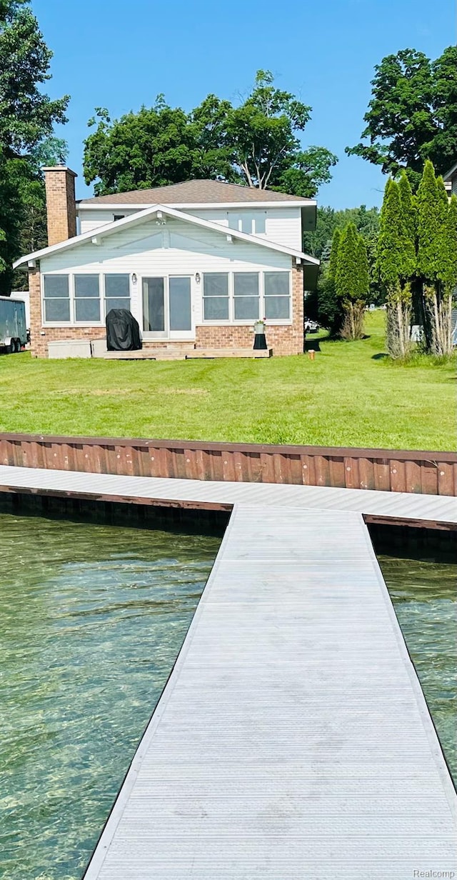 11375 SW Torch Lake Dr, Rapid City, MI 49676 - dock area featuring a water view and a lawn