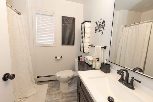 bathroom featuring vanity, toilet, and baseboard heating