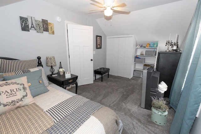 bedroom with a closet, ceiling fan, carpet, and vaulted ceiling