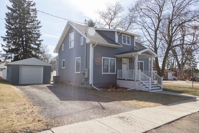 bungalow-style house featuring a shingled roof, a detached garage, gravel driveway, a porch, and an outbuilding