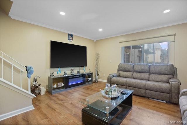 living area with recessed lighting, wood finished floors, baseboards, stairs, and crown molding