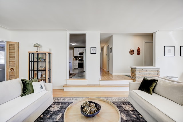 living area with wood finished floors and baseboards