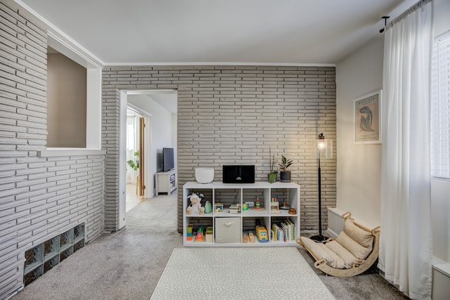 interior space featuring brick wall and ornamental molding