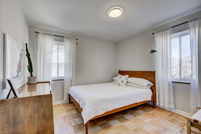 bedroom featuring multiple windows and baseboards