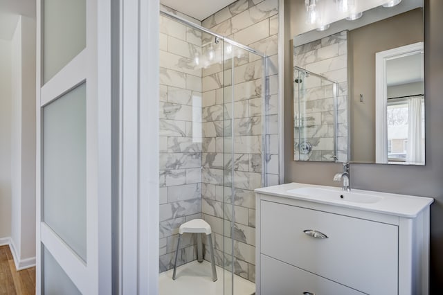 bathroom featuring a shower stall and vanity