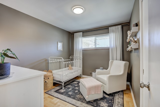 bedroom with a crib and baseboards