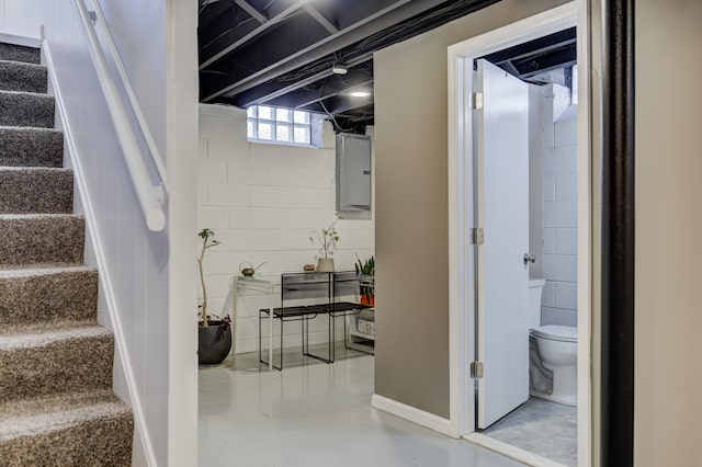 basement featuring electric panel and stairs