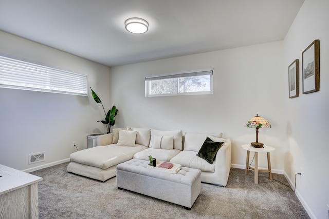 living room featuring carpet floors, baseboards, and visible vents