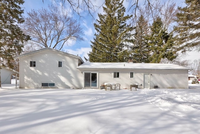 view of snow covered rear of property