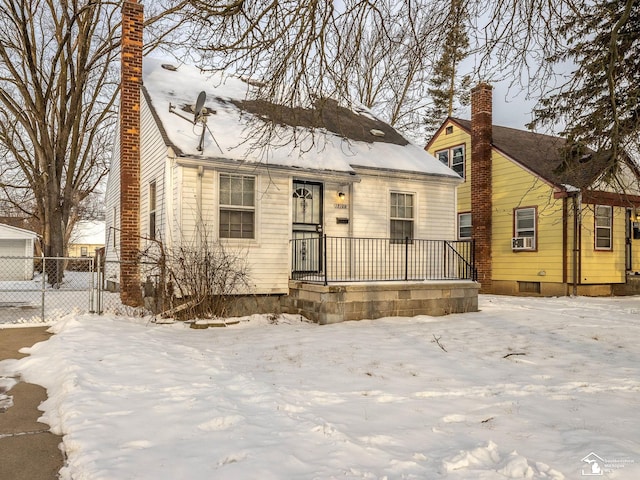 view of front of house with a chimney and fence