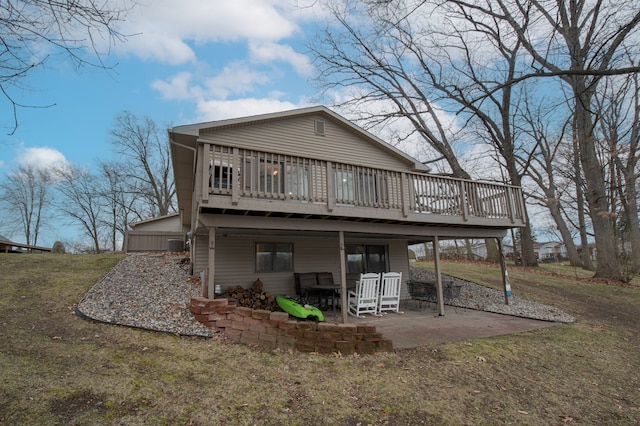 back of property with a deck and a patio