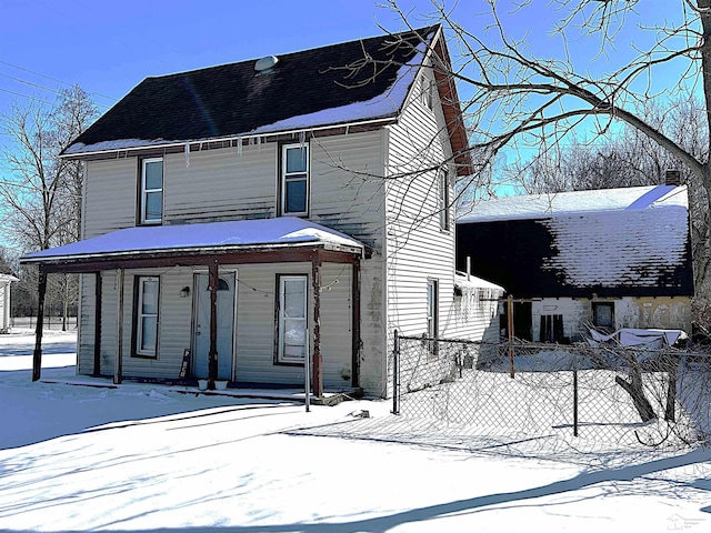 view of front of property with fence and a porch