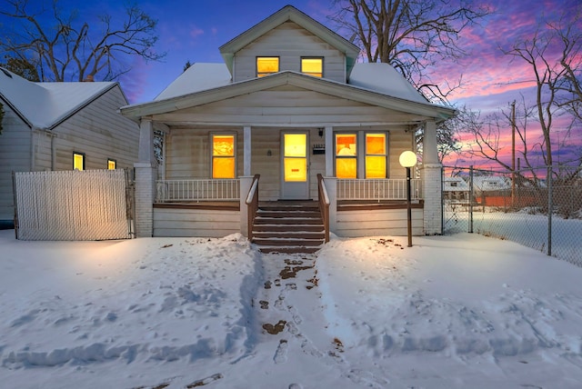 view of front of property featuring covered porch, fence, and a gate