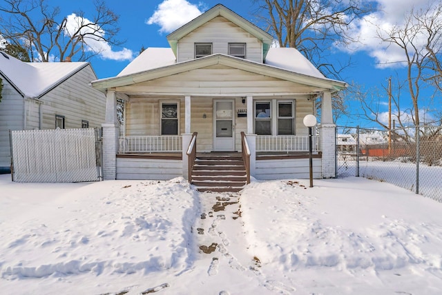 bungalow-style home with a porch and fence