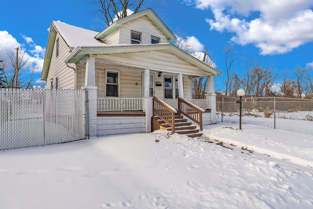 view of front of home featuring a porch and fence