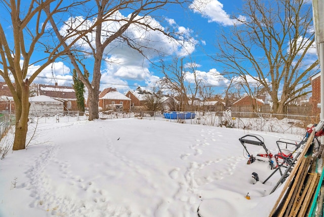 yard layered in snow with fence