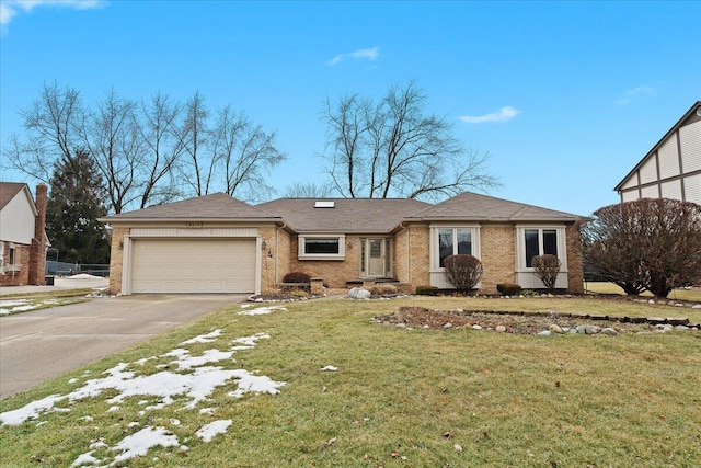 view of front of home featuring a front lawn, brick siding, driveway, and an attached garage