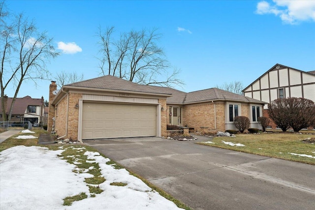 view of front of house with a garage, brick siding, and driveway