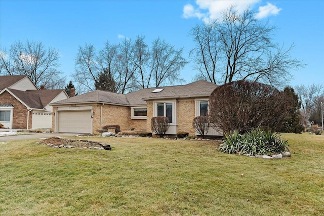 single story home featuring a front yard, brick siding, driveway, and an attached garage