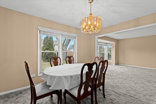 dining space featuring carpet floors, a chandelier, plenty of natural light, and baseboards