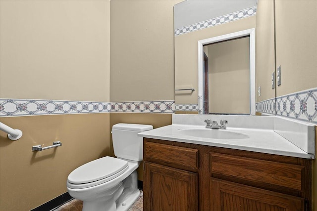 half bathroom featuring toilet and vanity