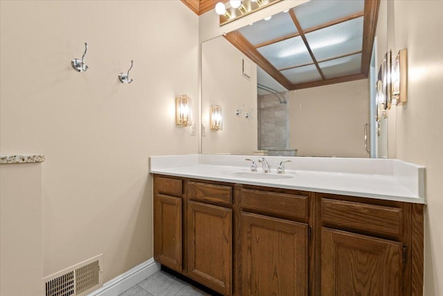 bathroom featuring vanity, visible vents, baseboards, a shower, and tile patterned floors