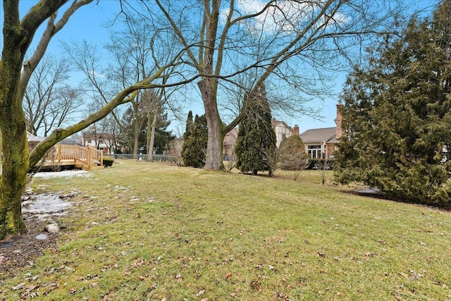 view of yard featuring fence and a deck