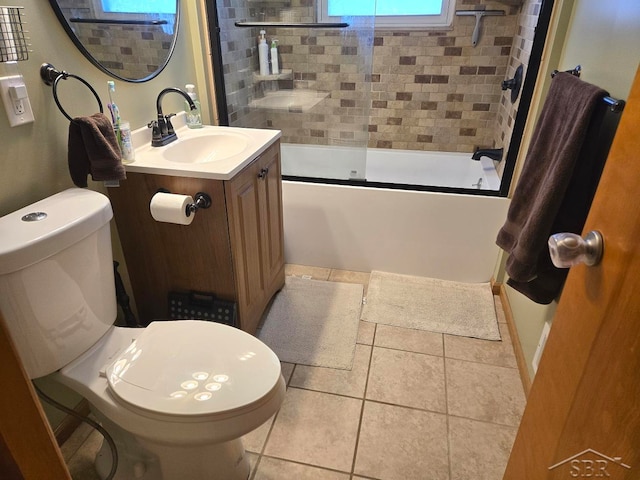 full bathroom featuring tile patterned flooring, combined bath / shower with glass door, vanity, and toilet