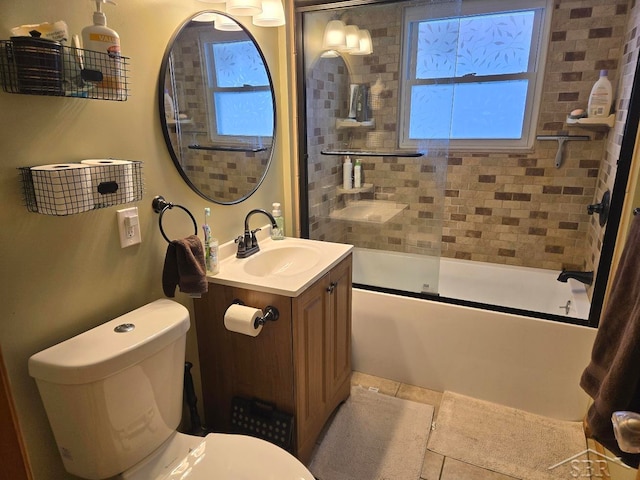 bathroom with enclosed tub / shower combo, vanity, toilet, and tile patterned floors