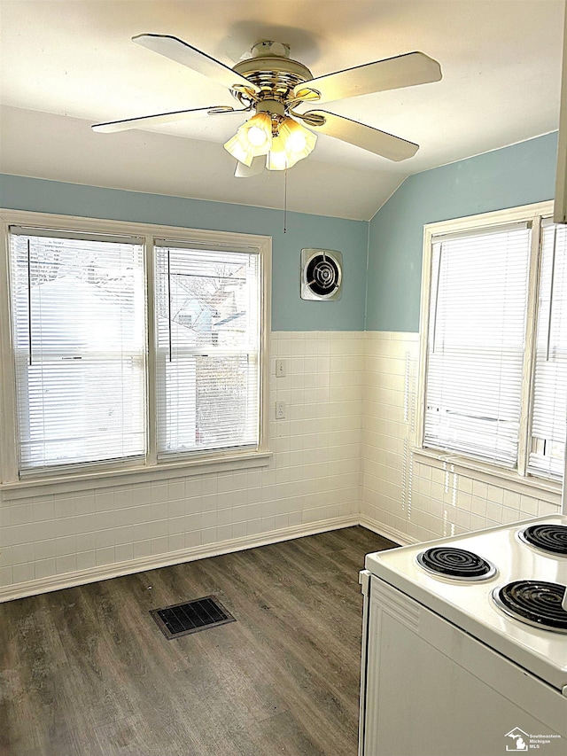 kitchen featuring visible vents, tile walls, dark wood-style flooring, and electric stove