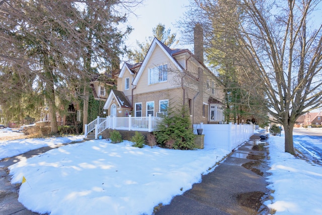 view of front facade featuring fence and brick siding