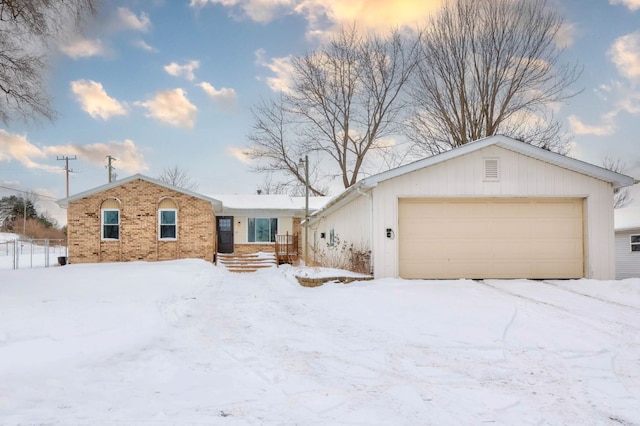 view of front of home with a garage and brick siding