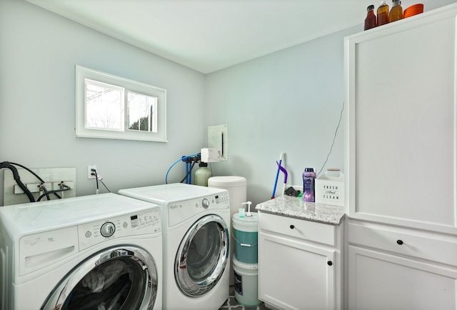 laundry area featuring washing machine and dryer and cabinet space