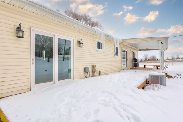 view of snow covered back of property