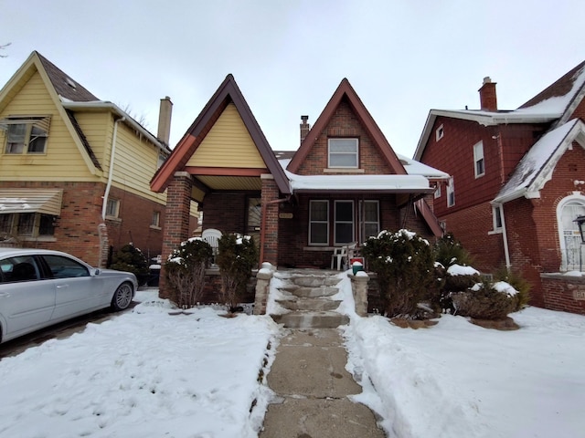 view of front of house featuring covered porch and brick siding