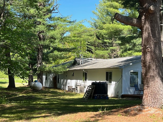 rear view of property featuring a lawn