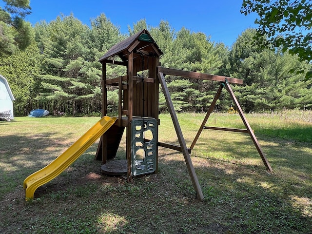 view of jungle gym featuring a lawn