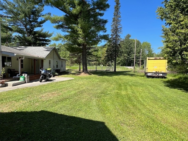 755 S M65 Rd, Twining, MI 48766 - view of grassy yard with a patio